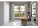 Comfortable home office featuring a modern desk, a rolling chair, natural light, and a view of the outdoors at 20318 W Turney Ave, Buckeye, AZ 85396