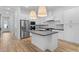 Modern kitchen featuring white cabinetry, stainless steel appliances, and a center island at 20318 W Turney Ave, Buckeye, AZ 85396