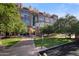 Multi-story brick building with manicured lawn, sidewalks, and mature shade trees on a clear day at 21 E 6Th St # 412, Tempe, AZ 85281