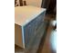 Modern kitchen island with white countertop and wooden cabinets with silver handles at 21 E 6Th St # 412, Tempe, AZ 85281