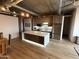 Open-concept kitchen with a large island, stainless steel appliances, and wood floors at 21 E 6Th St # 412, Tempe, AZ 85281