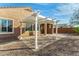 Beautiful backyard showcasing a charming pergola, brick patio, rock landscaping, and a view of the home at 21362 N 260Th Ln, Buckeye, AZ 85396