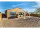 Attractive backyard with a pergola-covered patio, low-maintenance gravel landscaping, and a view of the home's exterior at 21362 N 260Th Ln, Buckeye, AZ 85396