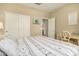 Bright bedroom with wood-look floors, white closet doors, and access to an ensuite bathroom at 21362 N 260Th Ln, Buckeye, AZ 85396