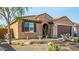 A charming home showcasing desert landscaping, shuttered windows, and a two-car garage at 21362 N 260Th Ln, Buckeye, AZ 85396