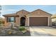 Charming home featuring desert landscaping, a two-car garage, and a cozy, covered entryway at 21362 N 260Th Ln, Buckeye, AZ 85396