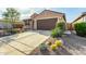 Inviting home with desert landscaping, a two car garage and a well-manicured front yard at 21362 N 260Th Ln, Buckeye, AZ 85396