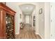 Spacious hallway with wood floors, arched doorways, and decorative accents for an elegant welcome at 21362 N 260Th Ln, Buckeye, AZ 85396