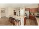 Bright kitchen featuring a large center island with seating, stainless steel appliances, and wood floors at 21362 N 260Th Ln, Buckeye, AZ 85396