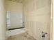 Unfinished bathroom featuring a white bathtub with shelving, awaiting final fixtures and finishes at 2401 E Spur Dr, San Tan Valley, AZ 85140