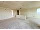 Spacious unfinished living room featuring multiple windows, awaiting final finishes and personalization at 2401 E Spur Dr, San Tan Valley, AZ 85140