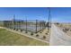 Enclosed pickleball courts with green and blue playing surfaces near a paved sidewalk at 2401 E Spur Dr, San Tan Valley, AZ 85140