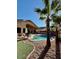 Gorgeous backyard features a sparkling pool surrounded by comfortable seating and mature palms at 2509 E Paraiso Dr, Phoenix, AZ 85024