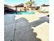 Backyard with a curved pool, patio, seating areas, and lush landscaping for outdoor enjoyment at 2509 E Paraiso Dr, Phoenix, AZ 85024