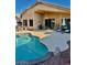 Lush backyard featuring a sparkling blue swimming pool, covered patio, and outdoor seating at 2509 E Paraiso Dr, Phoenix, AZ 85024