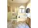 Bathroom featuring a bathtub with shower and decorative tile floor at 2509 E Paraiso Dr, Phoenix, AZ 85024