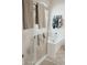 Bright bathroom featuring tub with glass door, neutral tile floors, and stylish towel racks at 2509 E Paraiso Dr, Phoenix, AZ 85024