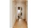 Hallway with wood flooring, white walls, and a view into a bedroom with natural light at 2509 E Paraiso Dr, Phoenix, AZ 85024