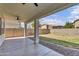 A covered backyard patio looks out to a private yard, rock bed and block fence at 2592 E Torrey Pines Ln, Chandler, AZ 85249