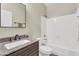 Bathroom featuring a granite countertop vanity with sink, a framed mirror, and a shower-tub combination at 2592 E Torrey Pines Ln, Chandler, AZ 85249