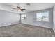 Bedroom featuring soft carpet, neutral walls, double windows, and a ceiling fan at 2592 E Torrey Pines Ln, Chandler, AZ 85249