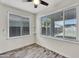 A bonus room with hardwood floors, modern lighting, and large windows providing natural light at 2592 E Torrey Pines Ln, Chandler, AZ 85249