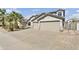 Attractive exterior view of a single-story home, three-car garage, and desert landscaping at 2592 E Torrey Pines Ln, Chandler, AZ 85249