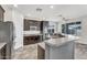 A kitchen with dark cabinetry, stainless steel appliances, light countertops, and modern wood flooring at 2592 E Torrey Pines Ln, Chandler, AZ 85249