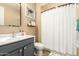 Well-lit bathroom featuring a modern vanity with a blue cabinet and framed mirror and framed art at 25955 W Deer Valley Rd, Buckeye, AZ 85396