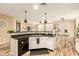 Open concept kitchen with white cabinets, dark countertops, and modern appliances flows into dining area at 25955 W Deer Valley Rd, Buckeye, AZ 85396