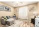 Inviting living room featuring a comfortable gray sofa and neutral decor with great natural lighting at 25955 W Deer Valley Rd, Buckeye, AZ 85396