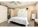 Bedroom featuring a stylish barn door, neutral tones, and a ceiling fan for a calm atmosphere at 25955 W Deer Valley Rd, Buckeye, AZ 85396