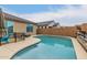 Inviting backyard pool area with a patio, fence, and lush landscaping for outdoor enjoyment at 25955 W Deer Valley Rd, Buckeye, AZ 85396