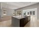 Open concept kitchen island with stainless steel sink and mountain views from the windows at 26657 W Renee Dr, Buckeye, AZ 85396