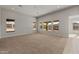 Spacious living area featuring tile and carpet flooring, large windows with outside views at 26657 W Renee Dr, Buckeye, AZ 85396