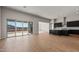 A modern kitchen with dark cabinets adjacent to a spacious living area at 26817 W Renee Dr, Buckeye, AZ 85396