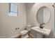 Contemporary powder room with pedestal sink and stylish fixtures at 26817 W Renee Dr, Buckeye, AZ 85396