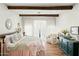 Bright bedroom featuring wood beam accents, a comfortable armchair, and lots of natural light at 28404 N 67Th St, Cave Creek, AZ 85331