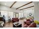 Open-concept living room featuring wood beam ceilings, hardwood floors, and ample natural light at 28404 N 67Th St, Cave Creek, AZ 85331