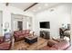 Spacious living room featuring a leather sofa, wood floors, and exposed beam at 28404 N 67Th St, Cave Creek, AZ 85331