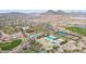 Scenic aerial view highlighting community pools, tennis courts, and a golf course amidst the desert at 30804 N 120Th Ave, Peoria, AZ 85383