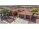 Beautiful aerial view of home with tile roof, desert landscaping, and three car garage at 30804 N 120Th Ave, Peoria, AZ 85383