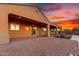 Paver patio with an attached covered area including a fire pit and outdoor lighting at 30804 N 120Th Ave, Peoria, AZ 85383