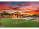 Expansive backyard featuring a pool, covered patio, and putting green at 30804 N 120Th Ave, Peoria, AZ 85383