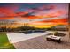 Beautiful backyard featuring a pool with water feature, fire pit, and desert landscaping at 30804 N 120Th Ave, Peoria, AZ 85383