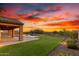 Backyard view featuring a pool, covered patio, putting green, and desert landscaping at 30804 N 120Th Ave, Peoria, AZ 85383