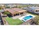 Gorgeous backyard featuring a sparkling pool, putting green, covered patio, and desert views at 30804 N 120Th Ave, Peoria, AZ 85383