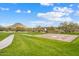 Community basketball court in grassy area with mountain views and walking path on a clear day at 30804 N 120Th Ave, Peoria, AZ 85383