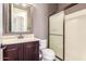 This bathroom features a wood vanity, a mirror, and a glass shower at 30804 N 120Th Ave, Peoria, AZ 85383