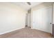 This carpeted bedroom features neutral colors, a ceiling fan, and closet at 30804 N 120Th Ave, Peoria, AZ 85383